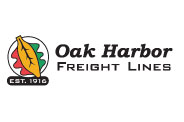 Logo of Oak Harbor Freight Lines featuring a stylized oak leaf with red and green backdrop. The text reads Oak Harbor Freight Lines with Est. 1916 below, highlighting their esteemed Freight Shipping Services legacy.
