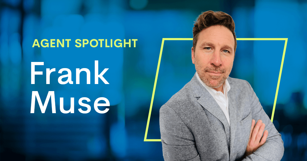 A man in a light gray blazer stands with arms crossed, looking at the camera. The text reads AGENT SPOTLIGHT Frank Muse, GlobalTranz freight agent, on a blue background with a yellow outline framing the man.